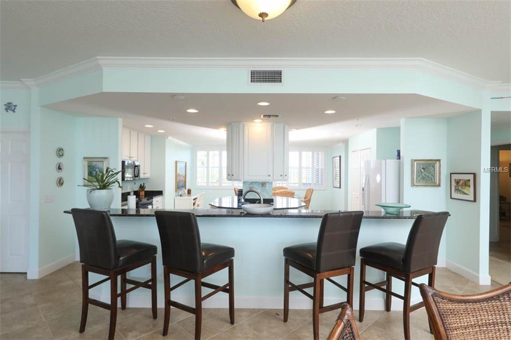 Highlights include over 3,300 sq feet of fabulous, one level living with plenty of space for family and friends. The chef’s kitchen affords tremendous counter and storage space as well as a built in wet-bar with wine refrigerator. 